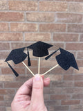black glitter graduation cap cupcake toppers on wooden sticks